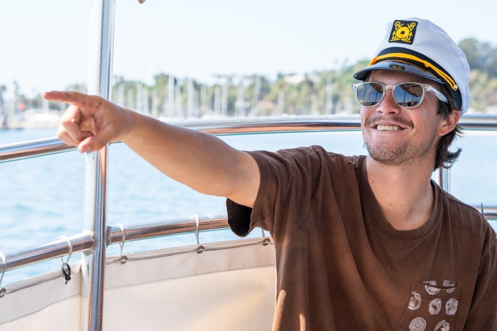 a man wearing a hat and sunglasses