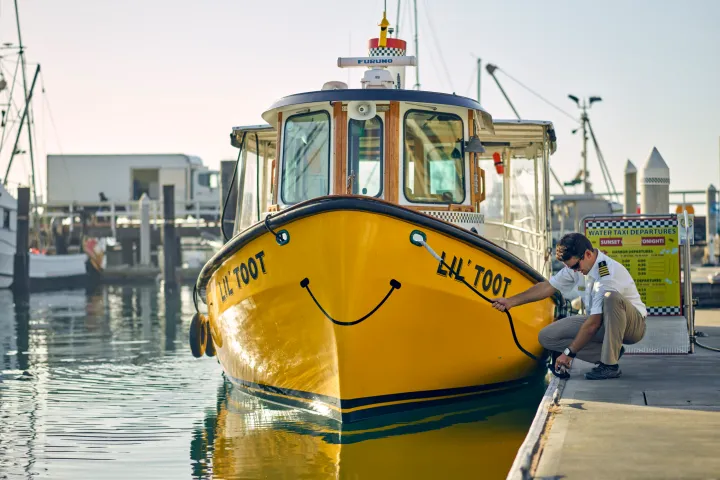 a boat that is sitting on a dock next to a body of water